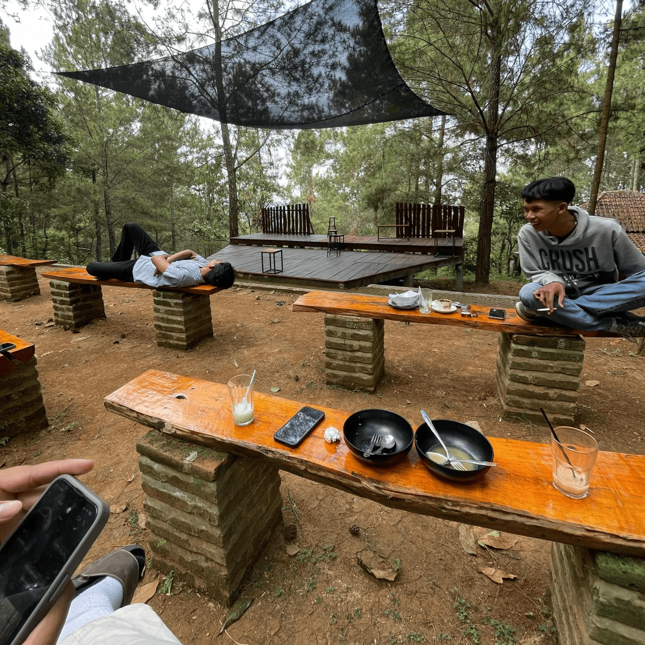 Indonesian students collaborating in a modern coffee shop