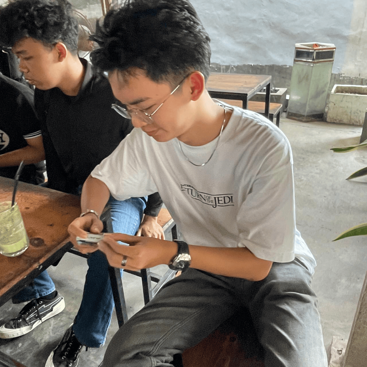 Moody barista steaming milk for coffee